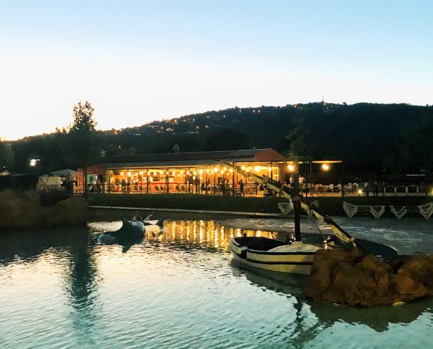 Decoration boat in the camping pool at sunset