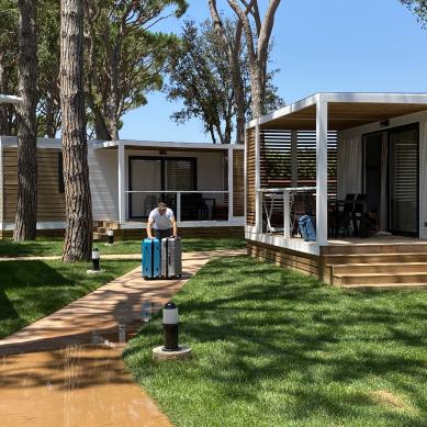 Person with luggage walking between the bungalows